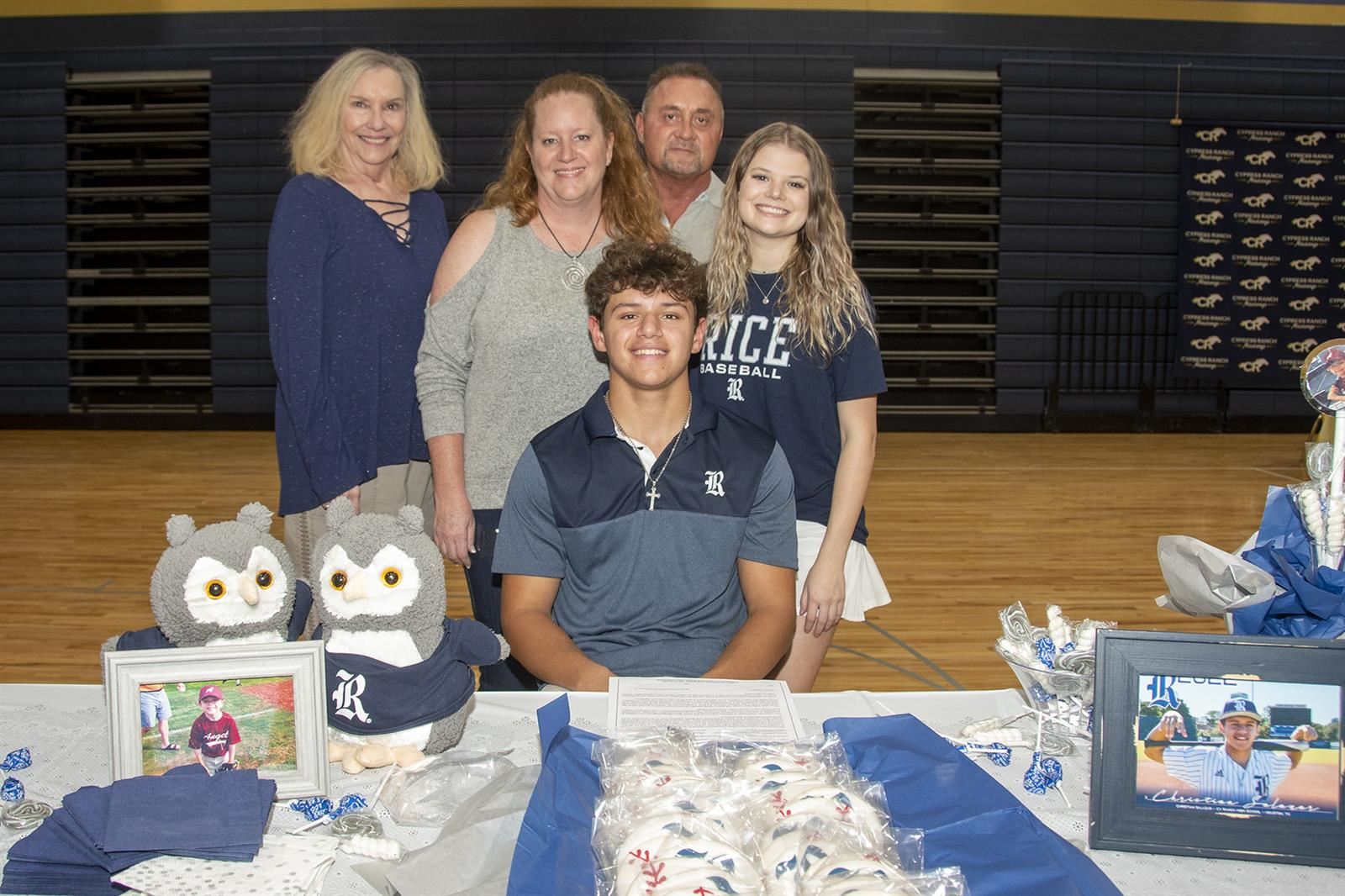 Cypress Ranch High School senior Christian Salazar, seated, poses with his family during the school’s signing day ceremony.